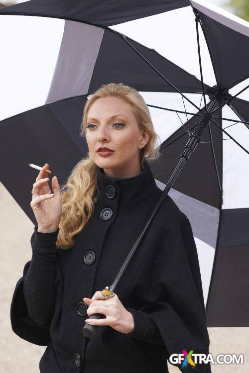 Women And Umbrella - Shutterstock 200xjpg