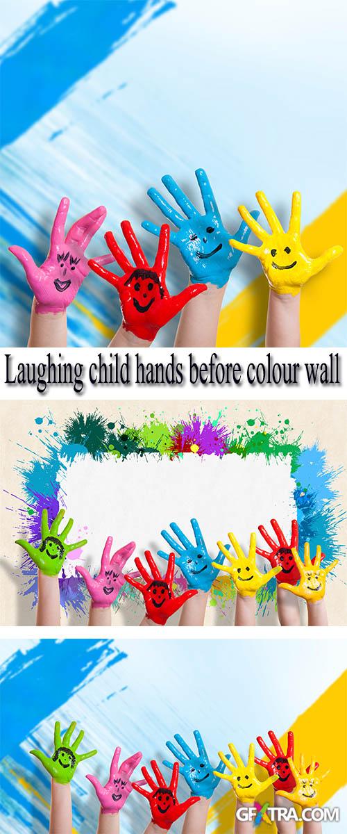 Stock Photo: Laughing child hands before colour wall