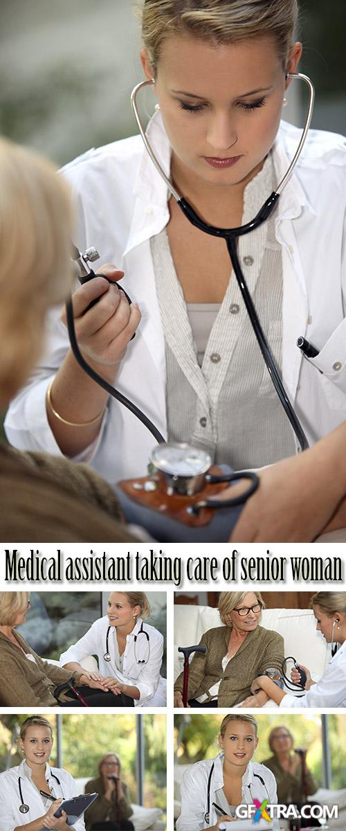 Stock Photo: Medical assistant taking care of senior woman