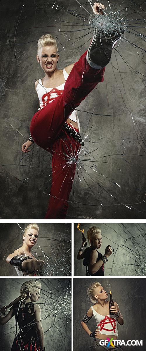 Stock Photo: Punk girl with a bat behind broken glass