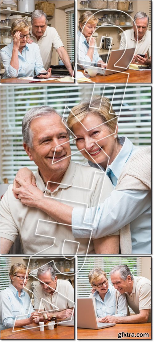 Senior couple working out their bills - Stock photo