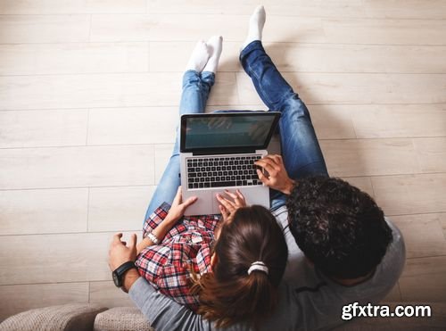 Stock Photos - Young Couple Sitting Using Laptop & Tablet