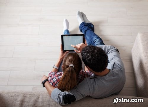 Stock Photos - Young Couple Sitting Using Laptop & Tablet