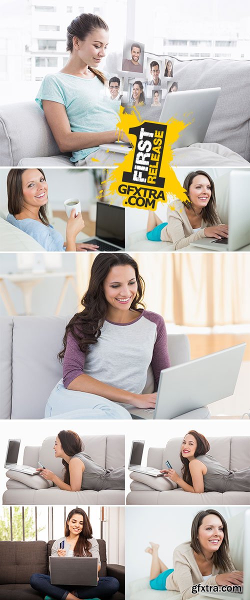 Stock Photo Happy woman sitting on couch using her laptop at home in the living room
