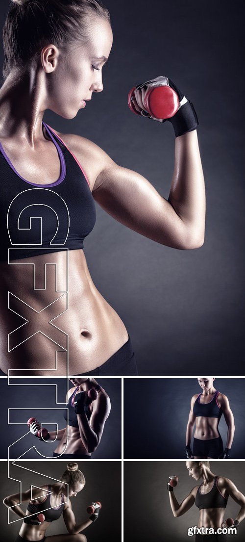 Stock Photos - A young woman playing sports with weights on a dark background