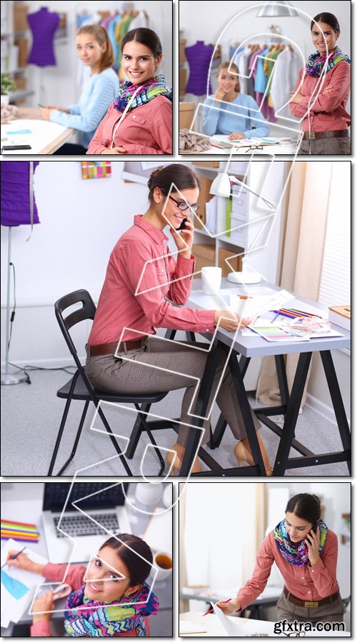 Young attractive female fashion designer working at office desk - Stock photo