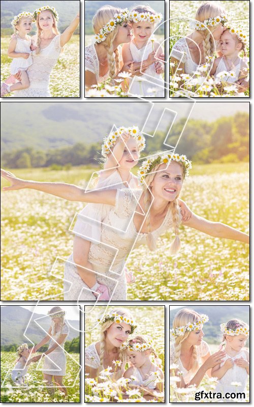 Happy family mother with cute little child girl in the chamomile field in spring - Stock photo