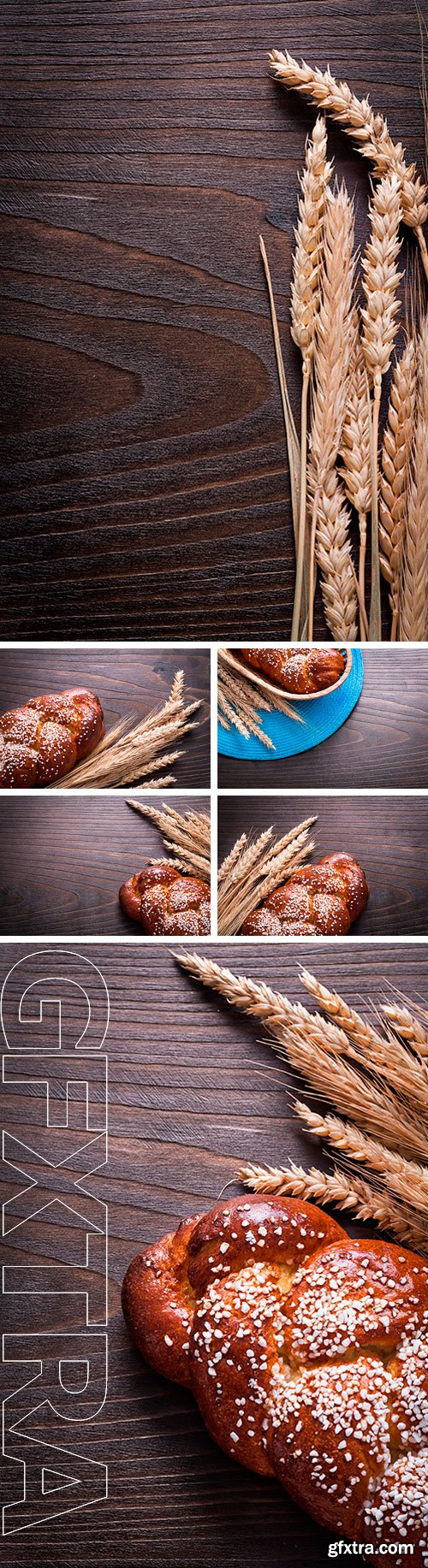 Stock Photos - Baked bun wheat rye ears on wooden board food and drink concept