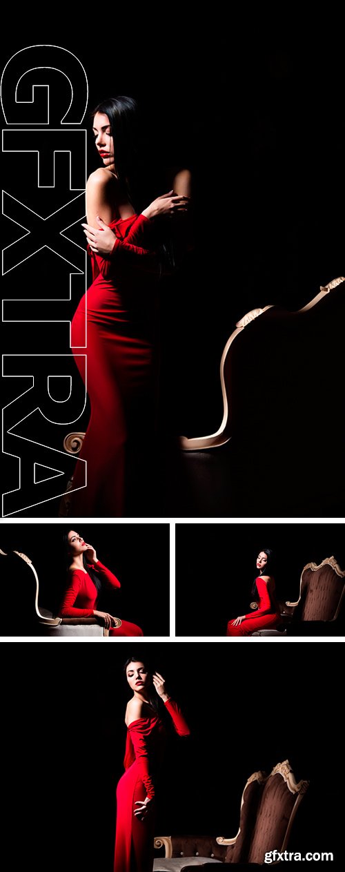 Stock Photos - Elegant woman in red dress in darkness. Female in dramatic light