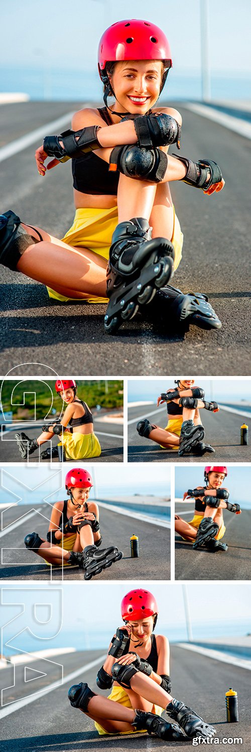 Stock Photos - Young sport woman with rollers in yellow skirt and red helmet with full protection wear sitting on the asphalt road