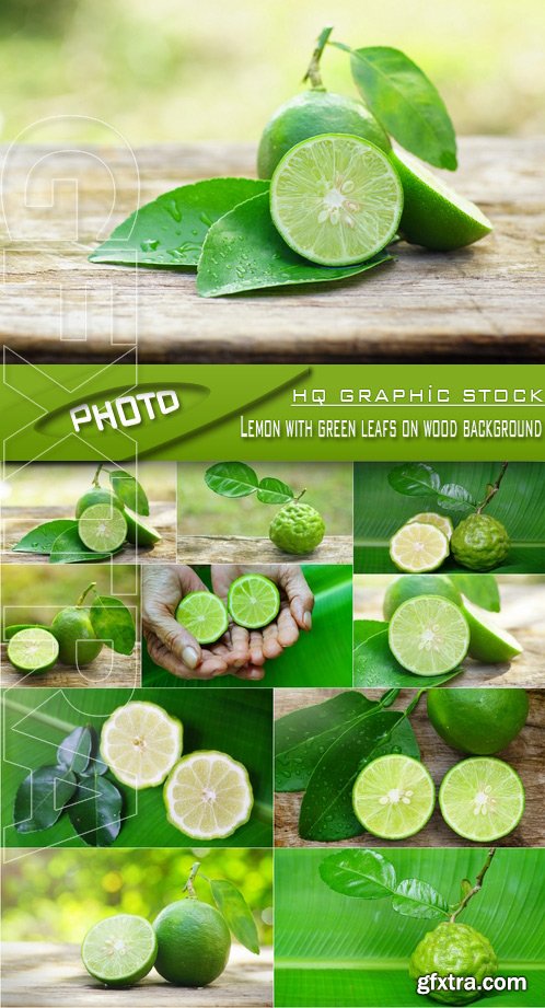 Stock Photo - Lemon with green leafs on wood background