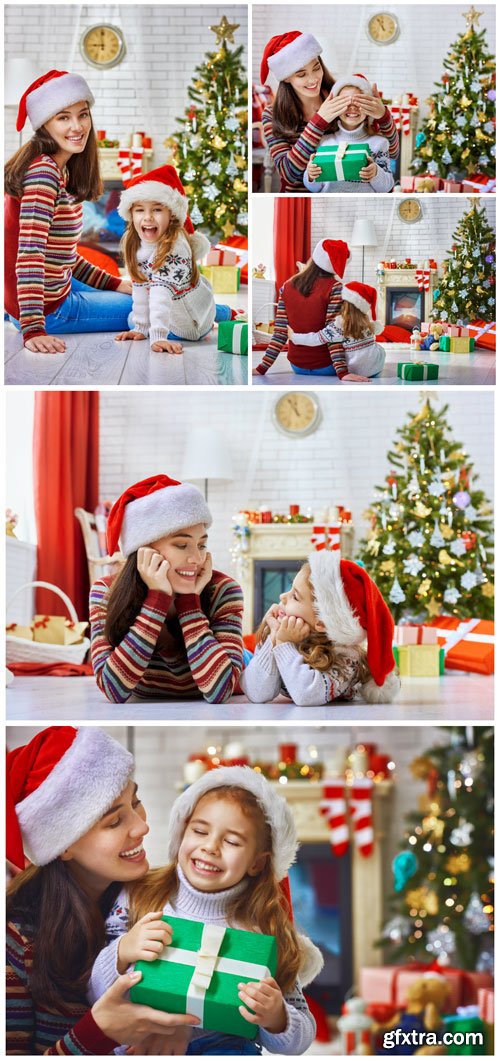 Family at Christmas tree, mother and daughter - Stock photo