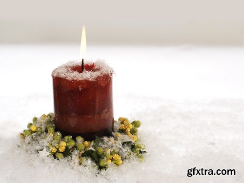 Christmas candle on snow