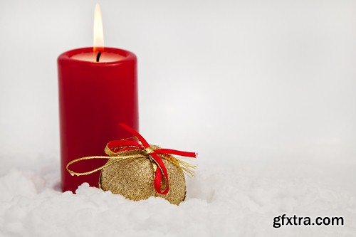 Christmas candle on snow