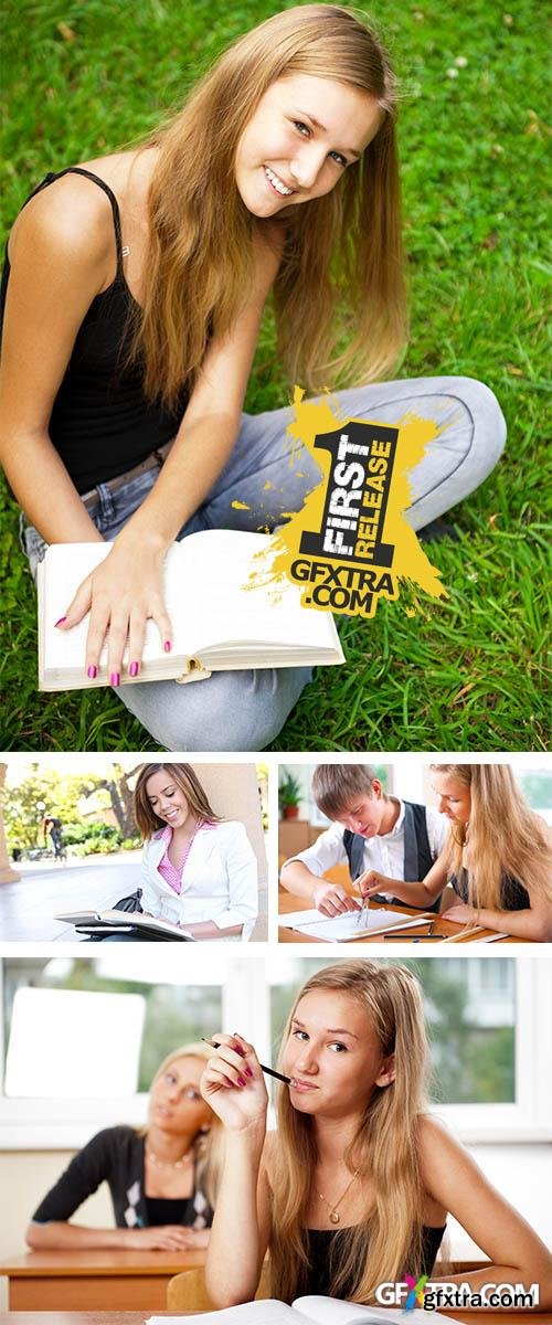 Stock Photo: A pretty young girl reading a book on the school campus