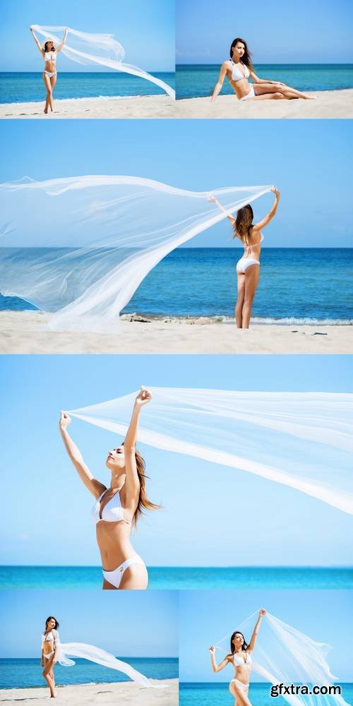 Young, Sporty and Happy Woman Posing with a Blowing Silk on a Summer Beach