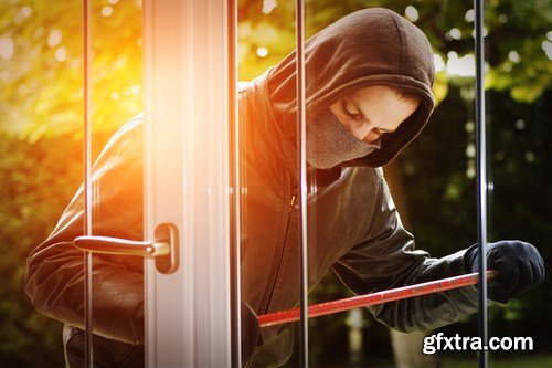 Burglar breaking in a house 7X JPEG