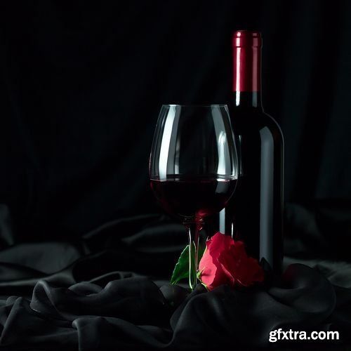 Red wine and rose against a drapery