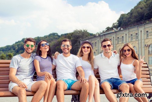 Group of diverse successful young  boyfriends and girlfriends having fun at summertime