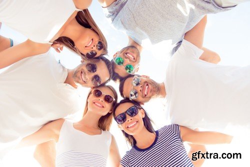 Group of diverse successful young  boyfriends and girlfriends having fun at summertime