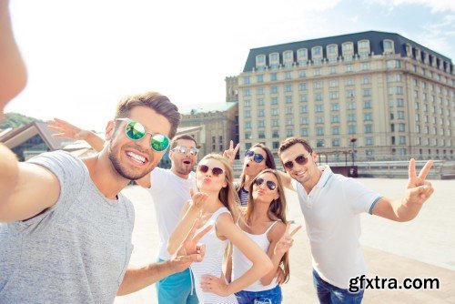 Group of diverse successful young  boyfriends and girlfriends having fun at summertime