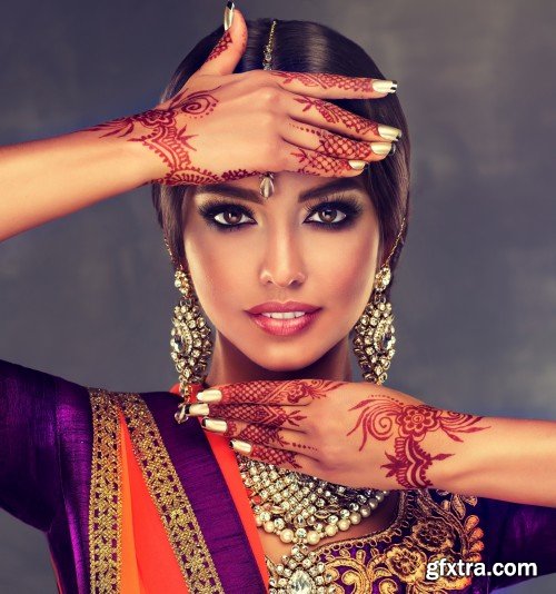 Portrait of beautiful indian girl, young hindu woman model with tatoo mehndi and kundan jewelry, traditional Indian costume lehenga choli