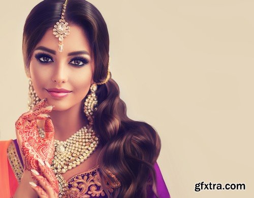 Portrait of beautiful indian girl, young hindu woman model with tatoo mehndi and kundan jewelry, traditional Indian costume lehenga choli