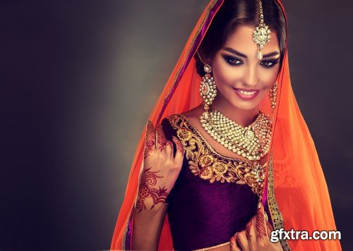 Portrait of beautiful indian girl, young hindu woman model with tatoo mehndi and kundan jewelry, traditional Indian costume lehenga choli