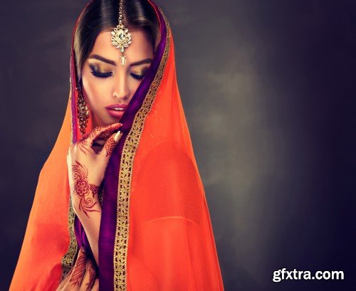 Portrait of beautiful indian girl, young hindu woman model with tatoo mehndi and kundan jewelry, traditional Indian costume lehenga choli