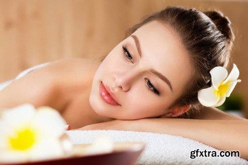 Beautiful young woman laying at spa salon