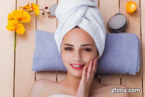 Beautiful young woman laying at spa salon