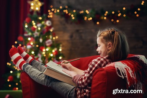 Happy family at Christmas, mother and daughter decorate the Christmas tree and exchange gifts