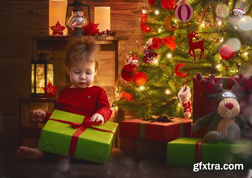 Happy family at Christmas, mother and daughter decorate the Christmas tree and exchange gifts