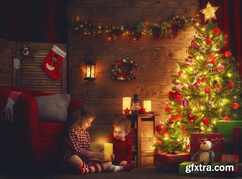 Happy family at Christmas, mother and daughter decorate the Christmas tree and exchange gifts