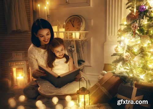 Happy family at Christmas, mother and daughter decorate the Christmas tree and exchange gifts