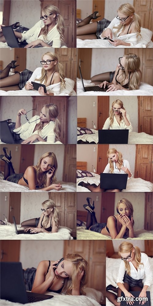 Sexy blonde woman typing on laptop in bed