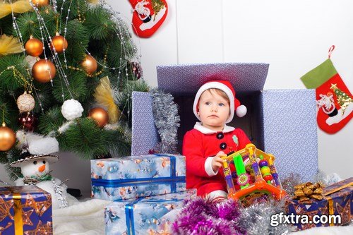 Cute little girl in Santa\'s suit near a Christmas tree - 19xUHQ JPEG Photo Stock