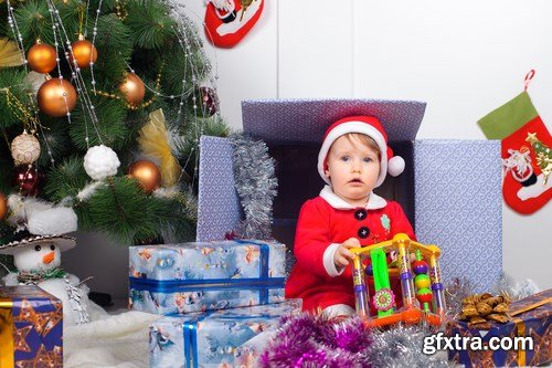 Cute little girl in Santa\'s suit near a Christmas tree - 19xUHQ JPEG Photo Stock