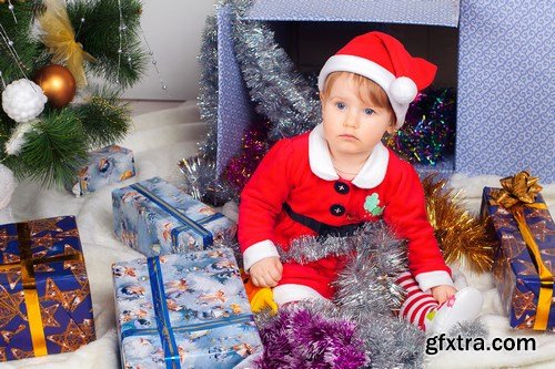 Cute little girl in Santa\'s suit near a Christmas tree - 19xUHQ JPEG Photo Stock