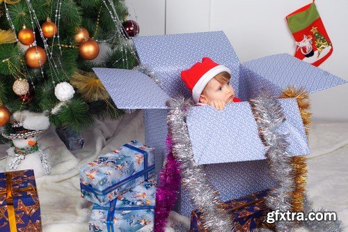 Cute little girl in Santa\'s suit near a Christmas tree - 19xUHQ JPEG Photo Stock