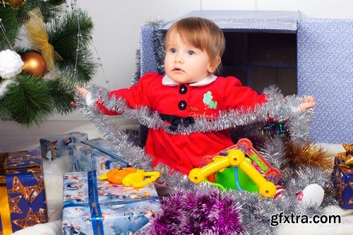 Cute little girl in Santa\'s suit near a Christmas tree - 19xUHQ JPEG Photo Stock