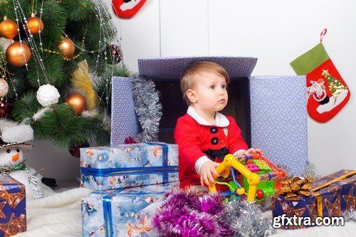 Cute little girl in Santa\'s suit near a Christmas tree - 19xUHQ JPEG Photo Stock