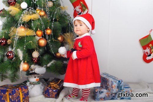 Cute little girl in Santa\'s suit near a Christmas tree - 19xUHQ JPEG Photo Stock