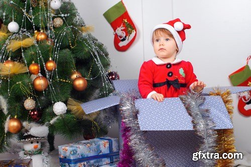 Cute little girl in Santa\'s suit near a Christmas tree - 19xUHQ JPEG Photo Stock