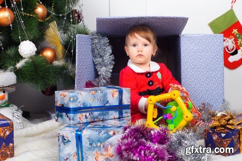 Cute little girl in Santa\'s suit near a Christmas tree - 19xUHQ JPEG Photo Stock