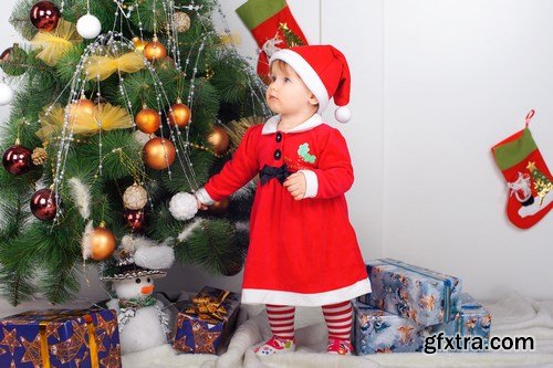 Cute little girl in Santa\'s suit near a Christmas tree - 19xUHQ JPEG Photo Stock