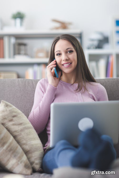 Beautiful young girl works with the smartphone and a laptop - 18xUHQ JPEG Photo Stock