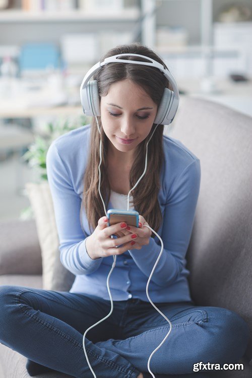 Beautiful young girl works with the smartphone and a laptop - 18xUHQ JPEG Photo Stock