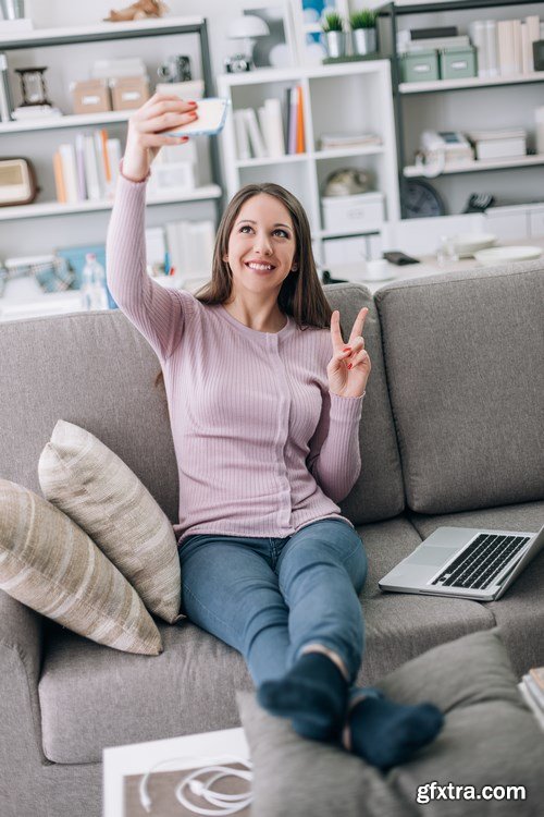 Beautiful young girl works with the smartphone and a laptop - 18xUHQ JPEG Photo Stock