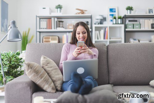 Beautiful young girl works with the smartphone and a laptop - 18xUHQ JPEG Photo Stock